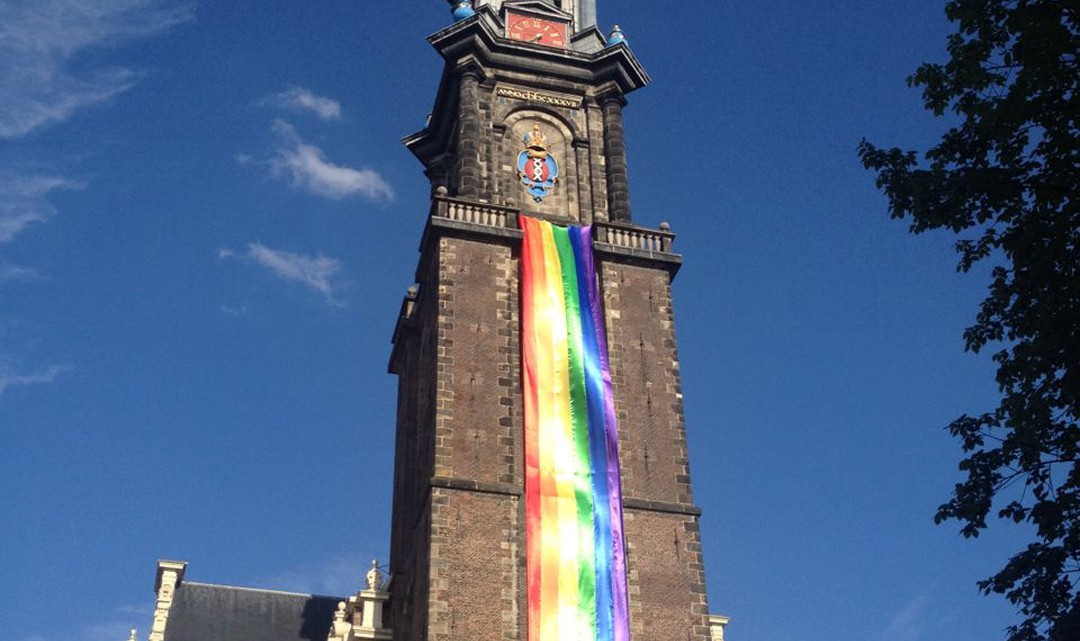 Westertoren with rainbow flag alongside against a blue sky