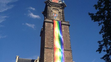 Westertoren with rainbow flag alongside against a blue sky