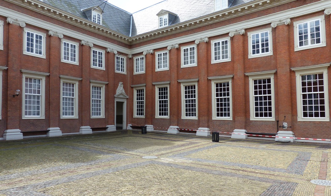 The paved courtyard with two sides of the museum's historic building