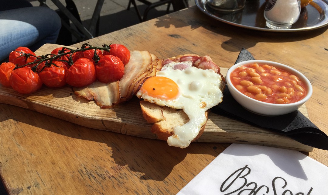 Full English breakfast on flat wooden plate