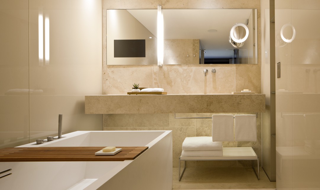 A beige marble bathroom, designed with clean, contemporary lines