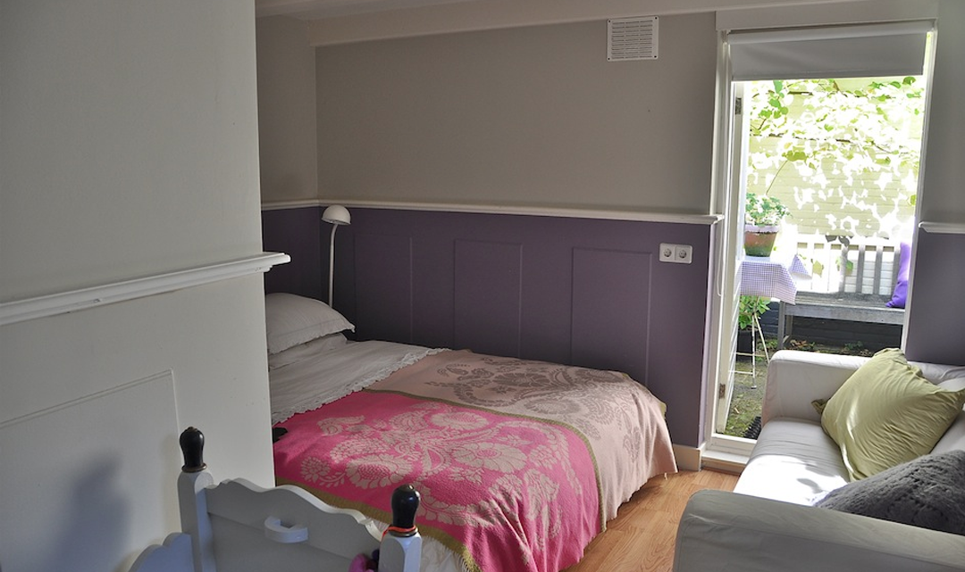 One of the bedrooms with aubergine and light grey walls