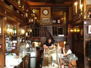 A view behind the bar with lots of wood paneling and original features