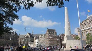 View over Dam Square, with the National war memorial in the foreground and the New Church and Royal Palace in the background