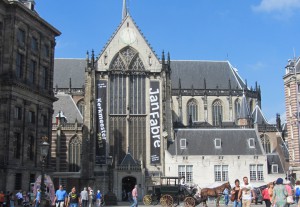 The main entrance of the New Church with left the Royal Palace and a tourist horse carriage in the front