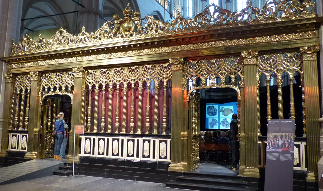 A richly decorated, golden choir screen of the New Church