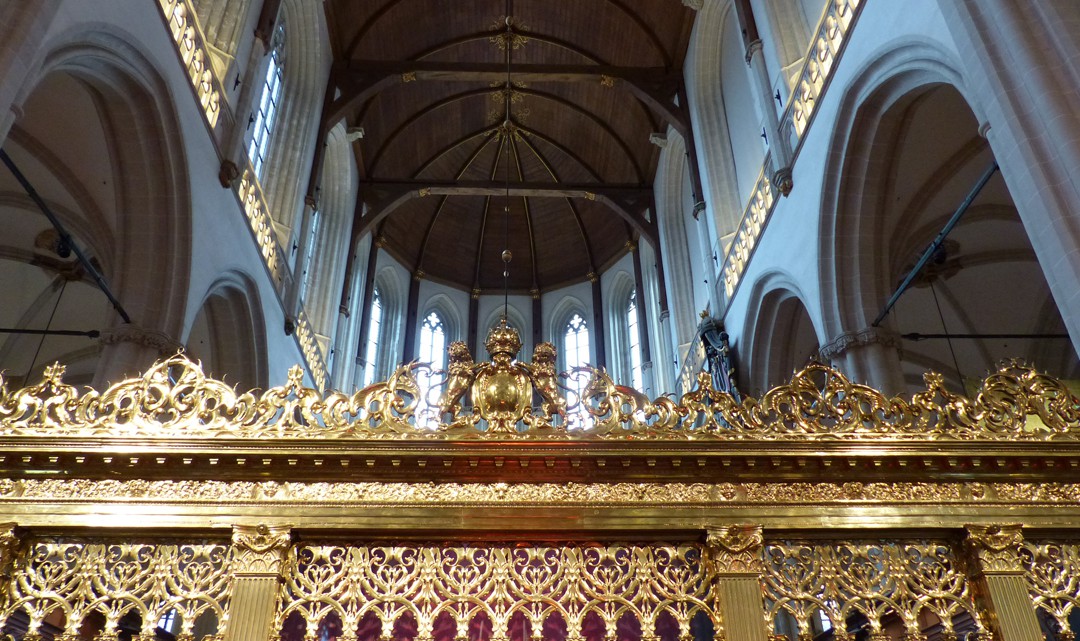 A view up in the church seeing the top of the golden choir screen and the wooden ceiling