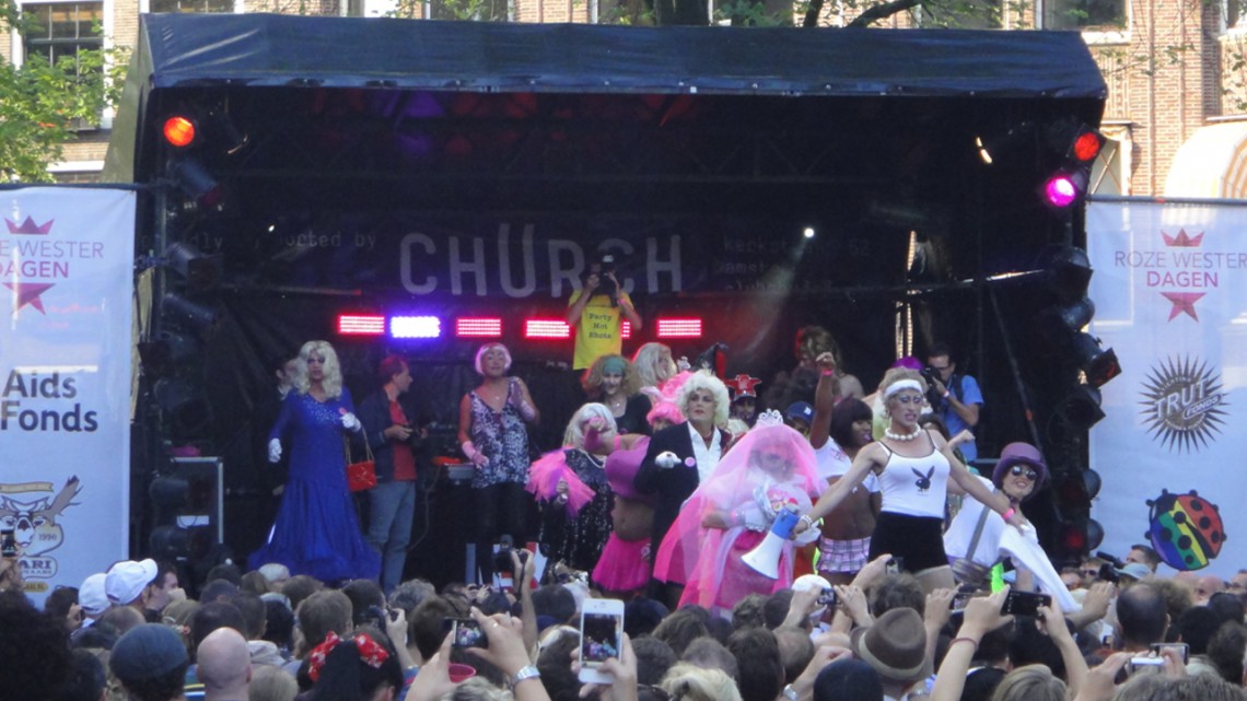 Drag queens and kings walk on stage