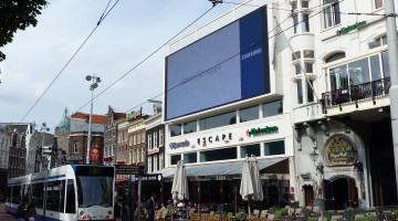 The building with a large LED screen on the gable