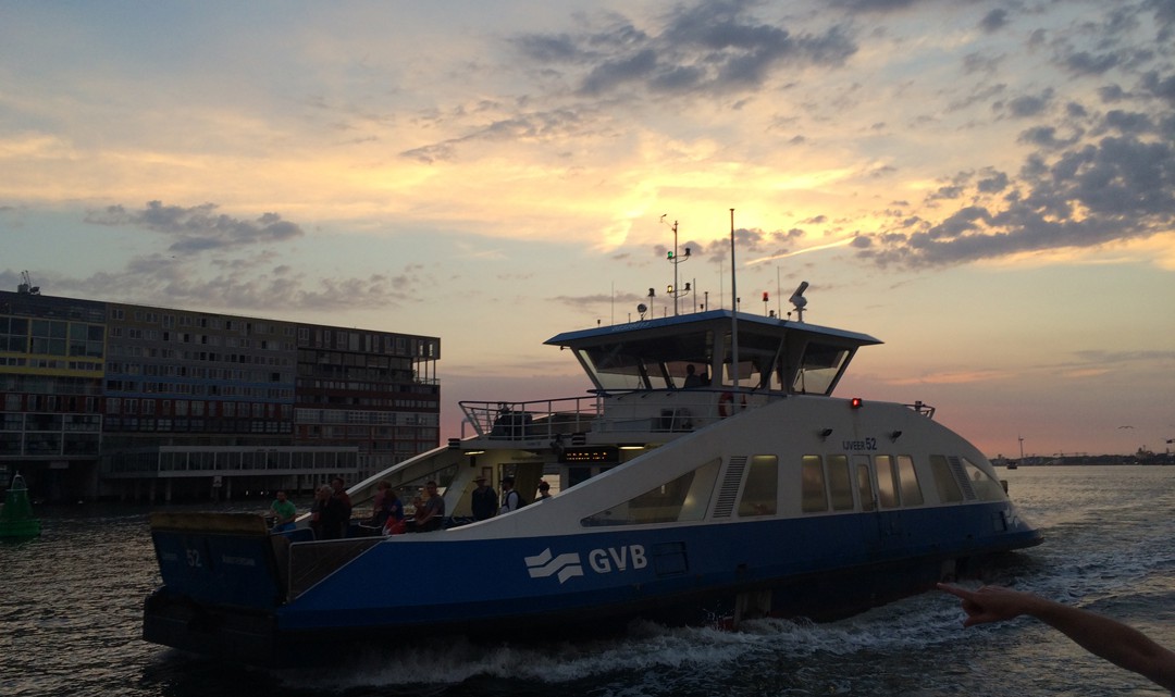 Ferry on the river IJ at sunset