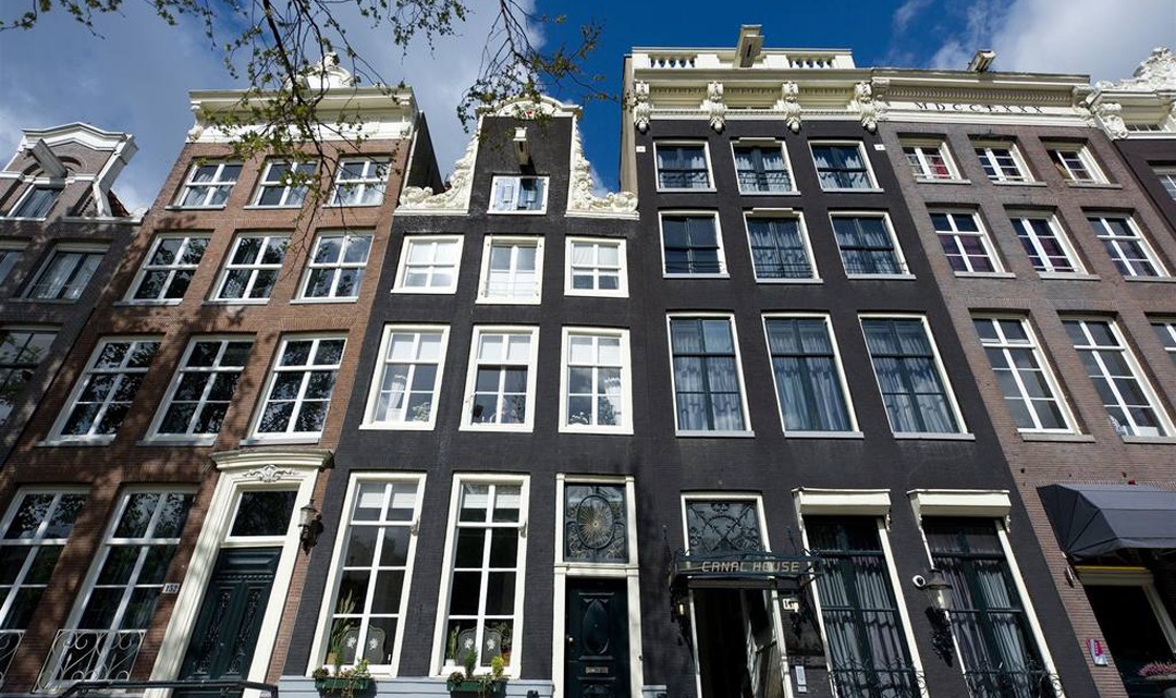 Amsterdam canal house gables against a blue sky