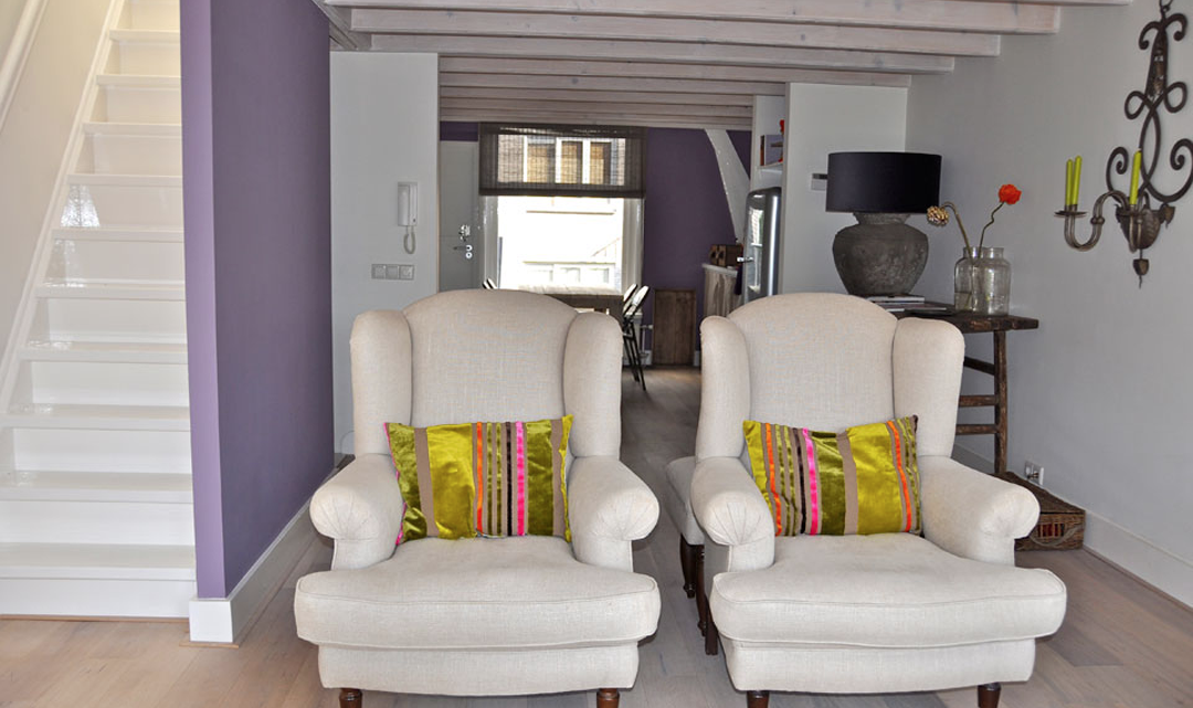 Two chairs in the foreground and the kitchen in the background