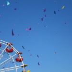 Quarter of a ferris wheel with confetti streamers flying through the air