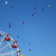 Quarter of a ferris wheel with confetti streamers flying through the air