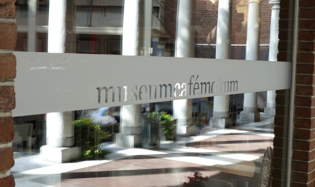 The text Museum Café Mokum on a partly sandblasted window