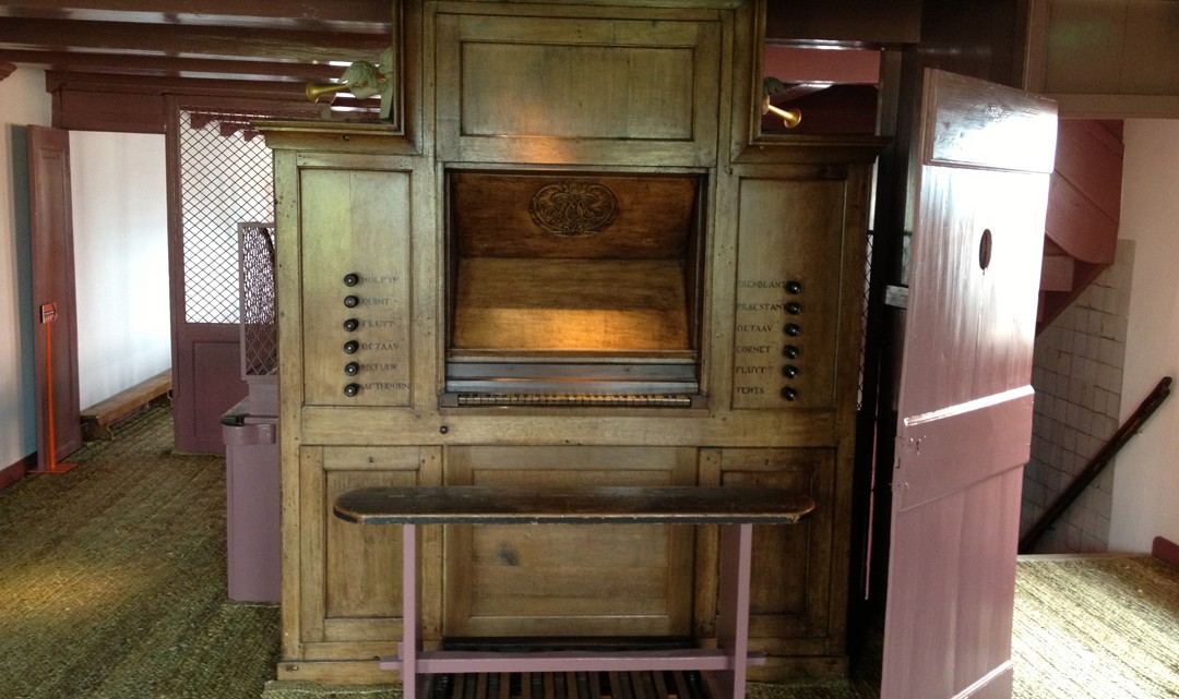 An wooden organ from the back (where the organist sits)