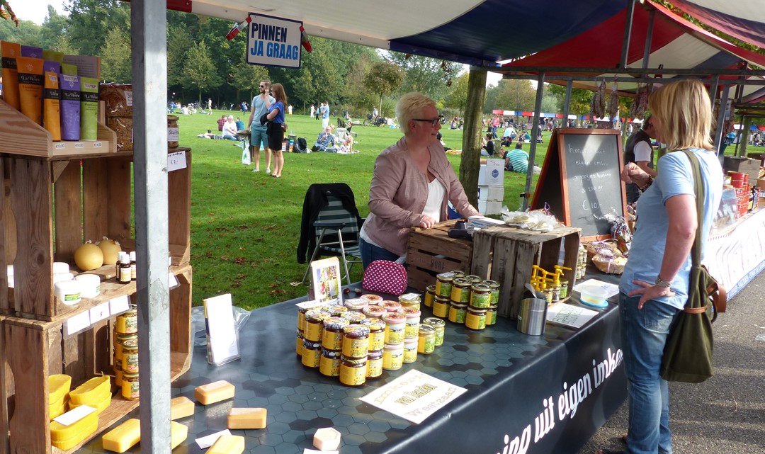 A market stall with stacks of honey pots , honey soaps and other products made from honey