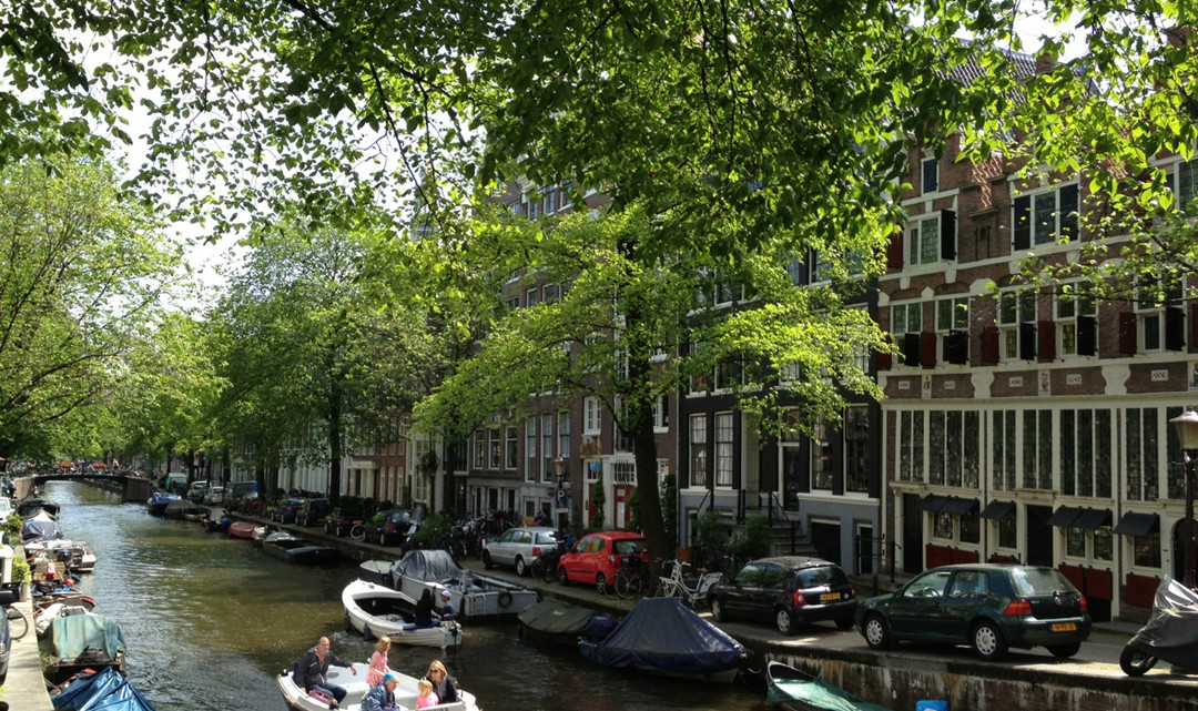 Two rental boats crossing each other on the canal