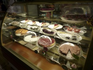 The cake display with various cakes, brownies, muffins and chocolates