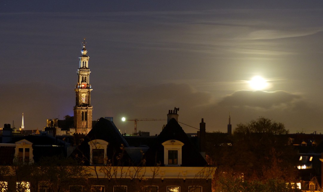 The Western Tower as viewed from a distance and the full moon next to it